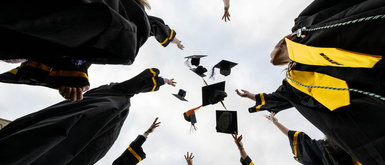 photo of graduation caps tossed in the air