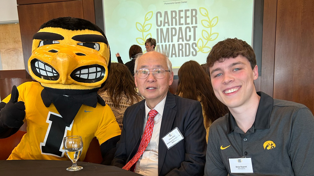 Photo of Dr. Shiu accepting the award for our department and Drew Dupont with Herky.
